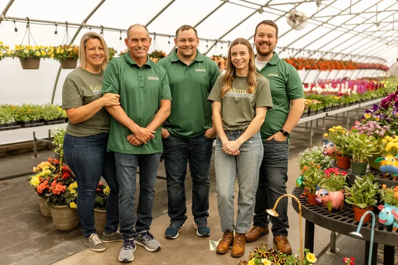 The five members of the Goldeman family standing together in the greenhouse